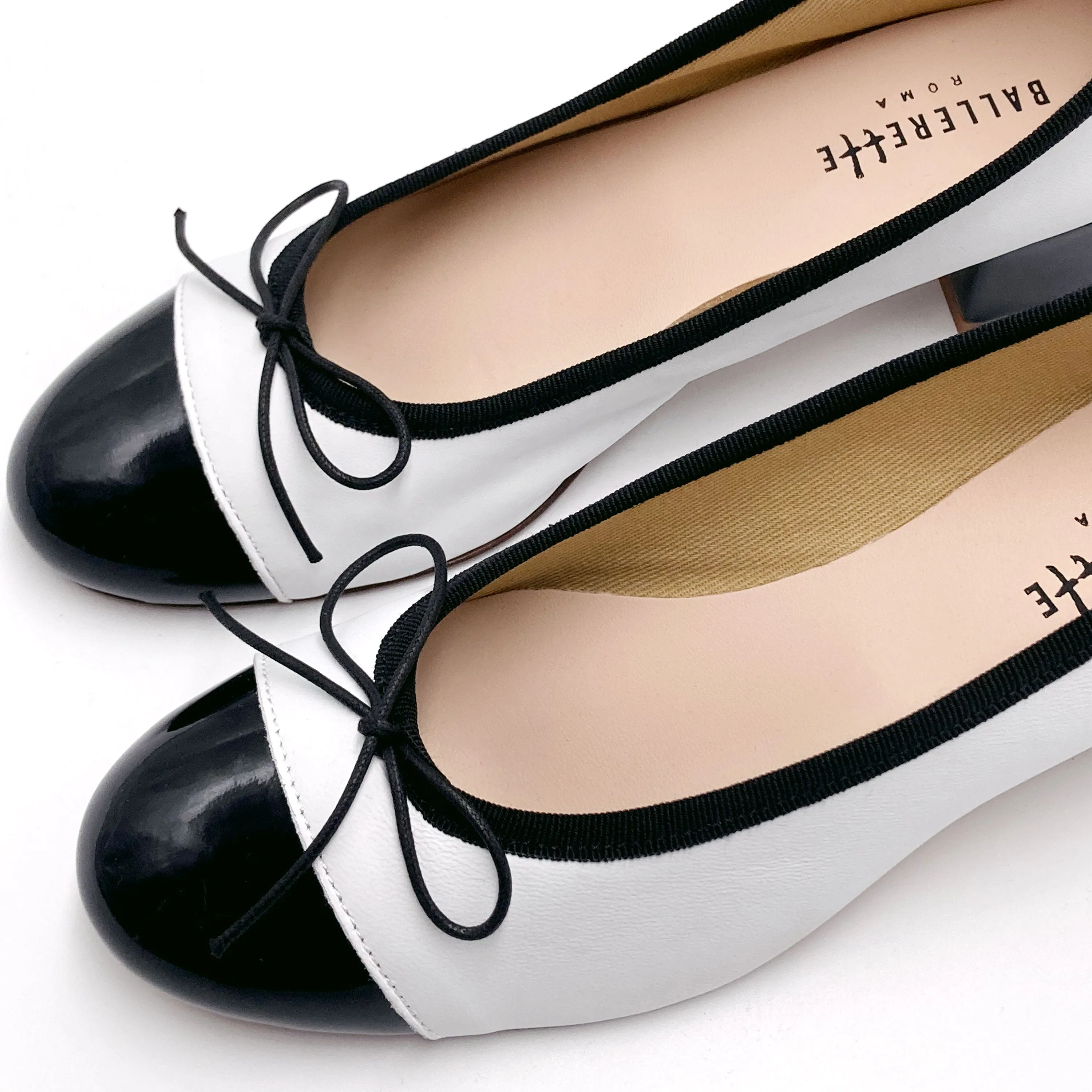 White leather ballet flats with high heel and patent toe